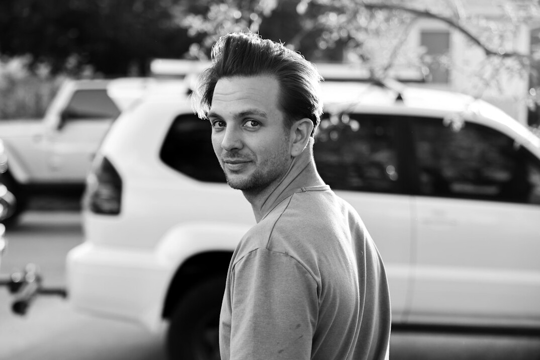 Portrait of a man in his thirties with a short beard and a casual shirt