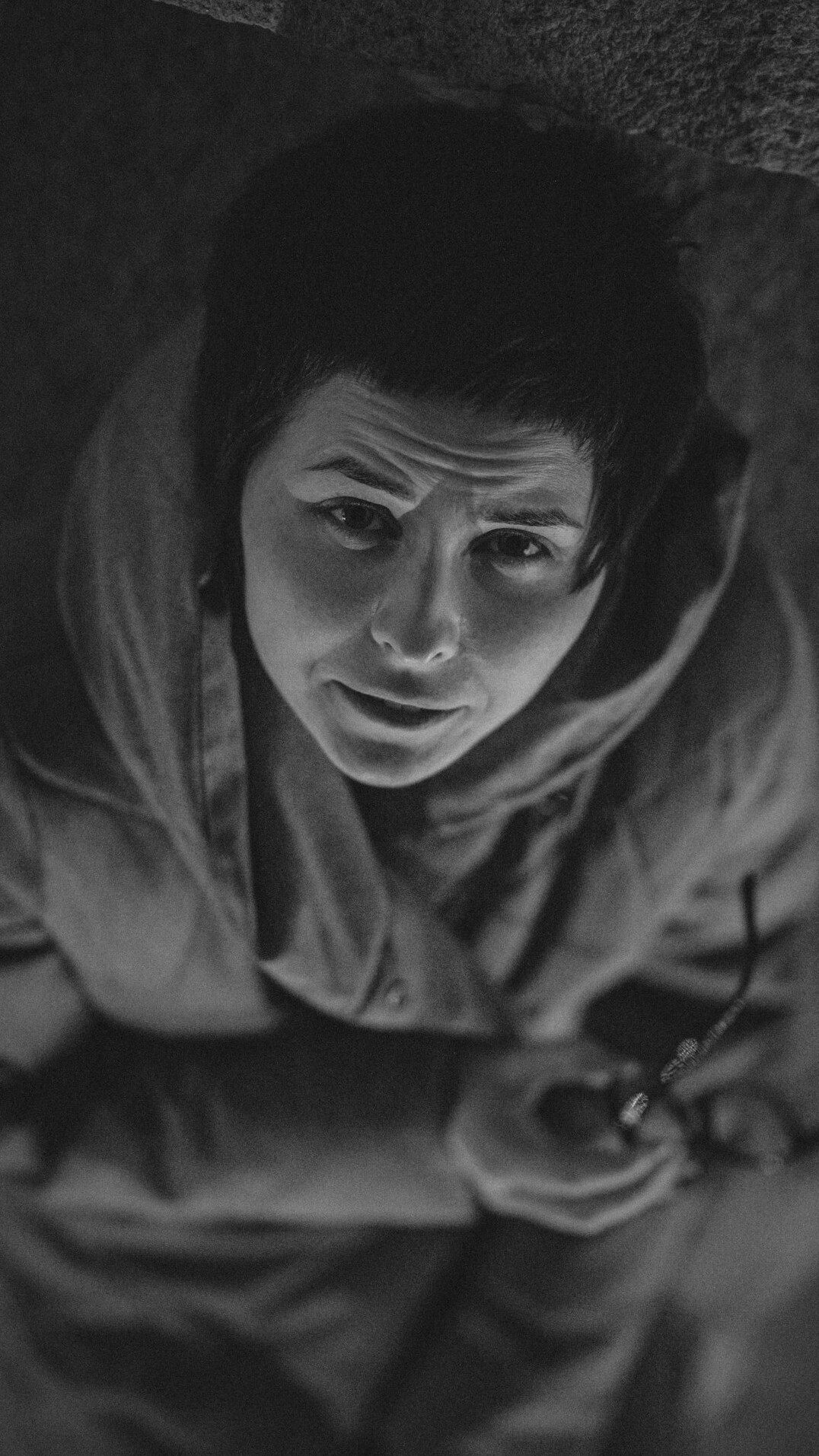 Portrait of a man in his late twenties with short dark hair wearing a hoodie